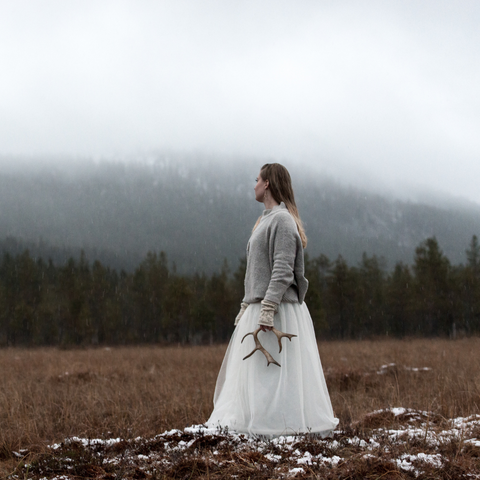 Valona brand photo with woman in the Nordic landscape with an antler