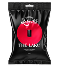 A 300g black stand-up pouch of Kouvolan Lakritsi 'The Laku' sweet liqueur, featuring a bold red circular graphic on the front, set against a transparent checkered background.