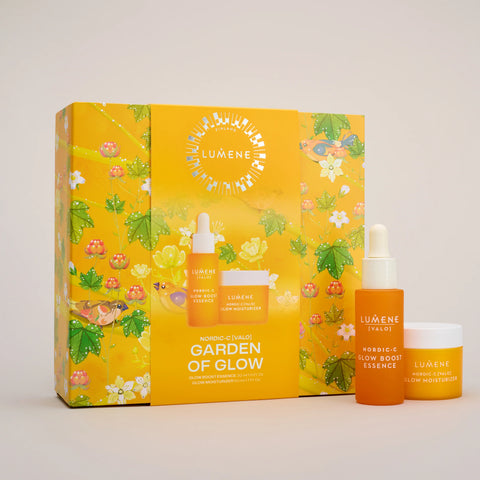 Luméne Paris 'Garden of Glow' skincare set featuring a bright yellow floral gift box with three products: a serum dropper bottle, a glow boostessence jar, and a glow moisturizer jar, displayed on a light gray background.